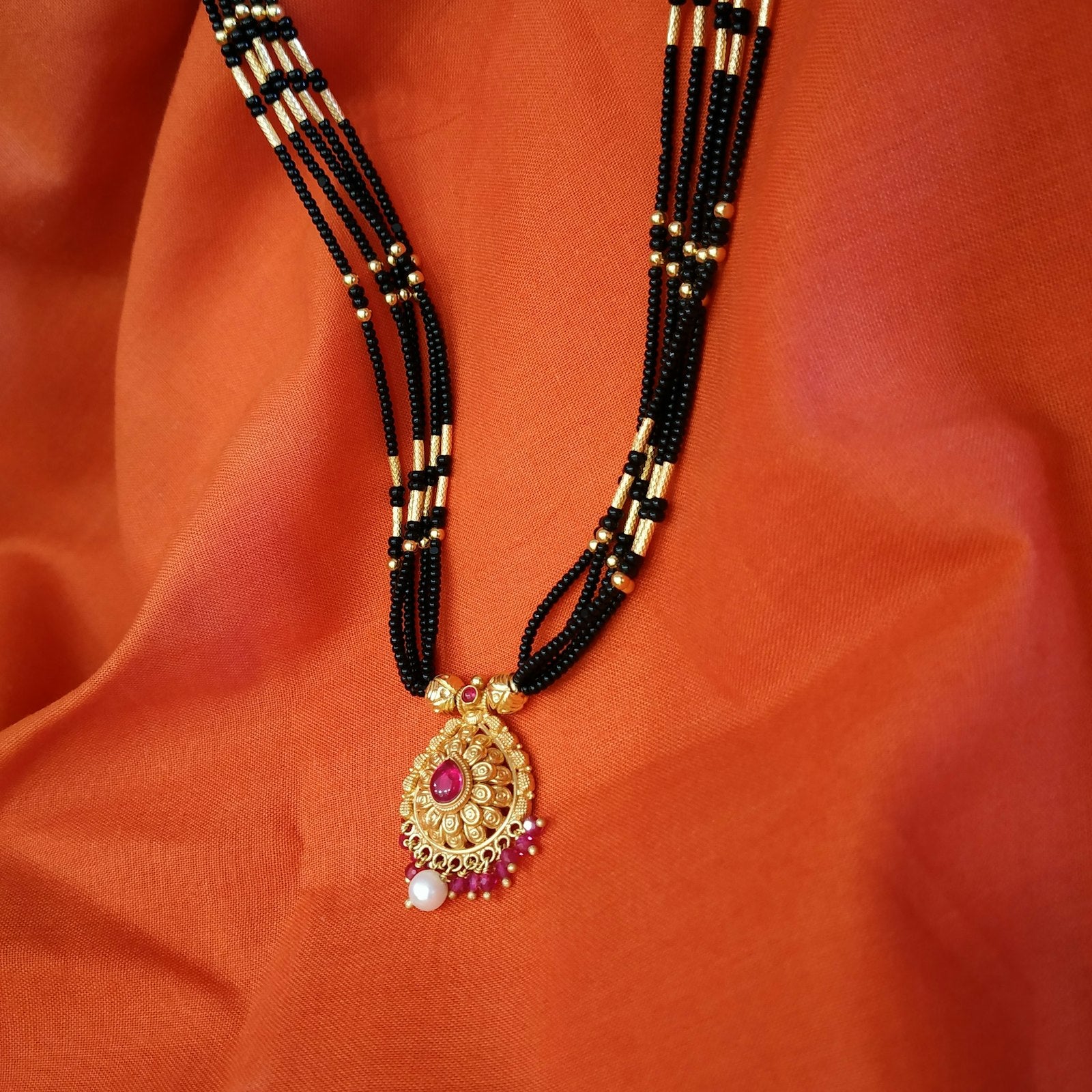 Beaded gold mangalsutra chains laid flat