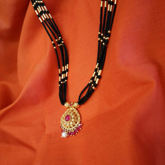 Beaded gold mangalsutra chains laid flat