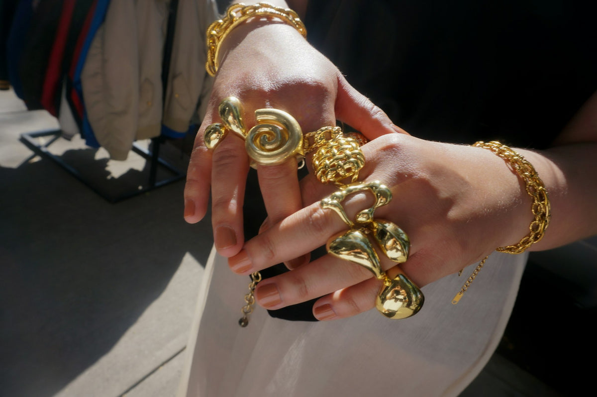 Chapha hero slide - hands with chunky gold rings and bracelets